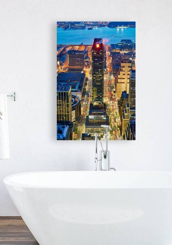 Aerial view of Manhattan at dusk showing city lights and buildin by Marco Brivio