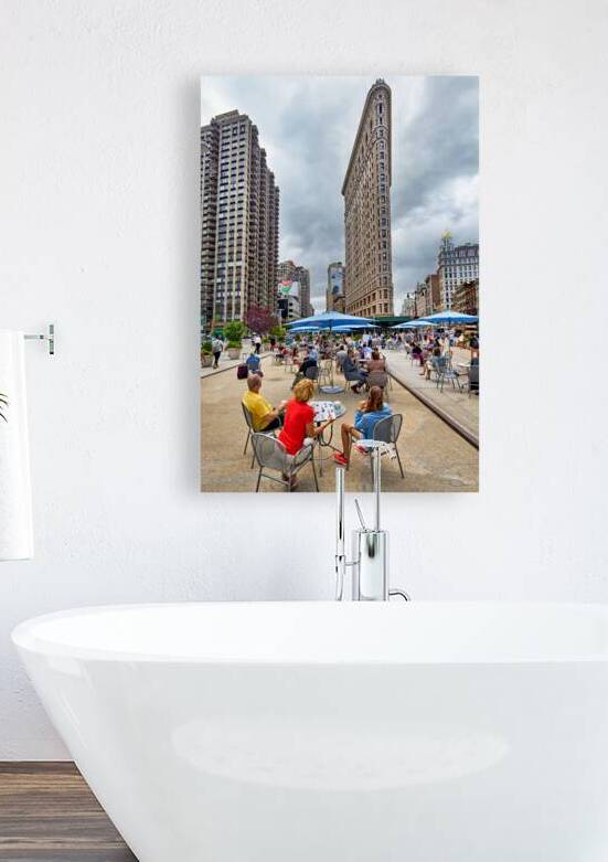 Visitors enjoy outdoor seating near the Flatiron Building in Man by Marco Brivio