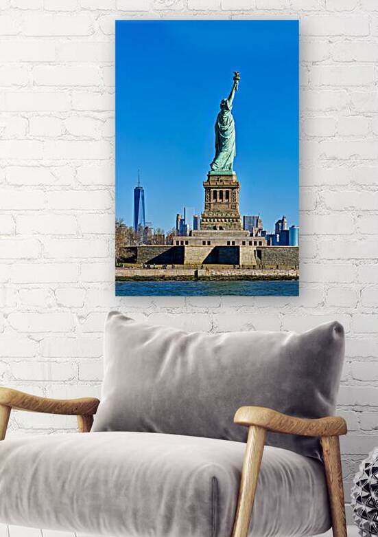 View of Statue of Liberty from Manhattan with city skyline behin by Marco Brivio