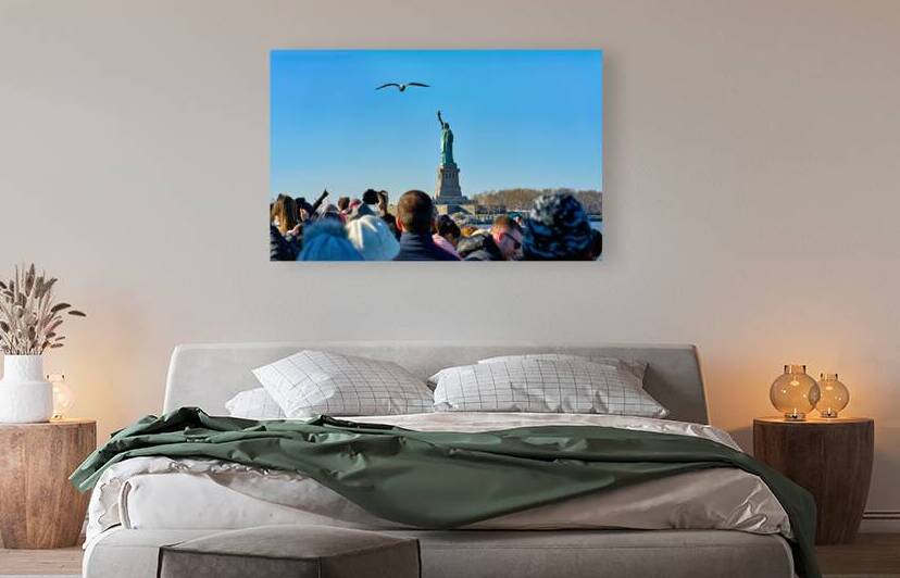 Tourists travel to Liberty Island by ferry in Manhattan New Yor by Marco Brivio