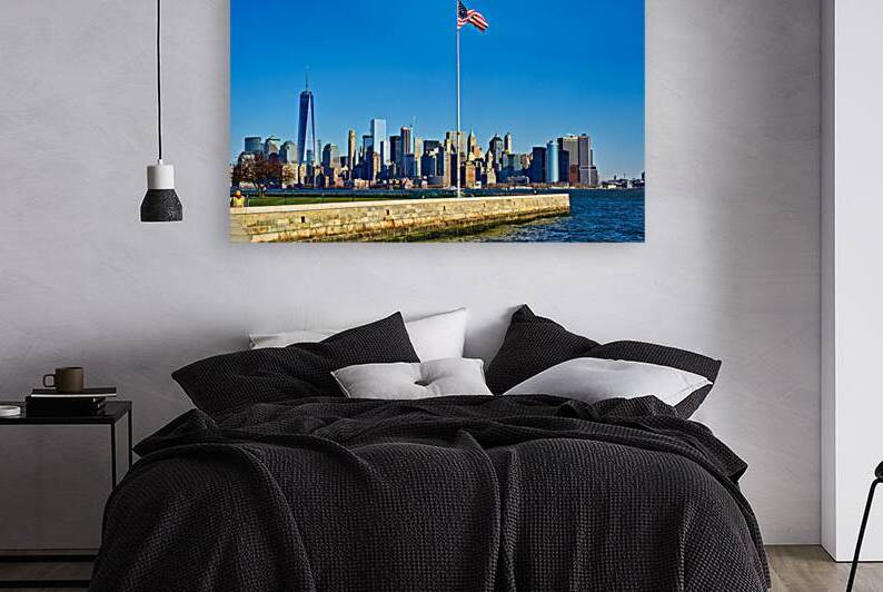 Manhattan skyline view from Liberty Island with American flag by Marco Brivio