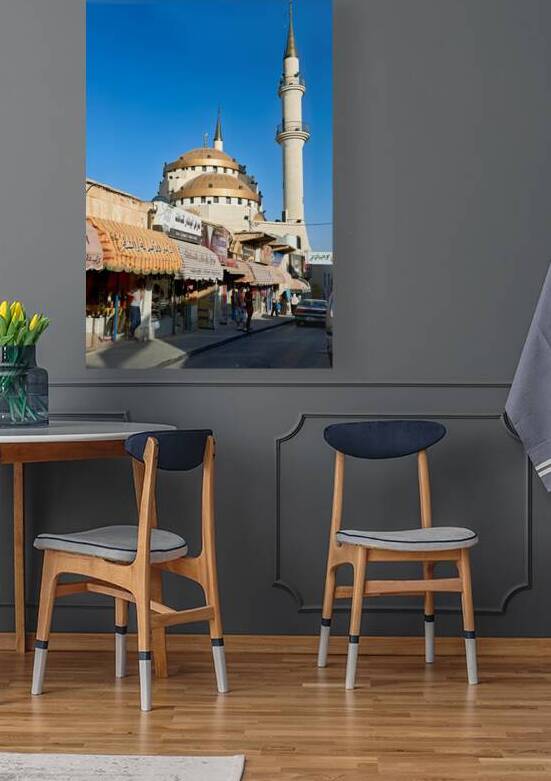 Mosque in Madaba Jordan with shops and street activity present by Marco Brivio