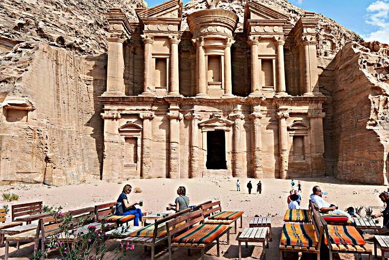 Tourists enjoy tea in front of the Monastery at Petra in Jordan by Marco Brivio