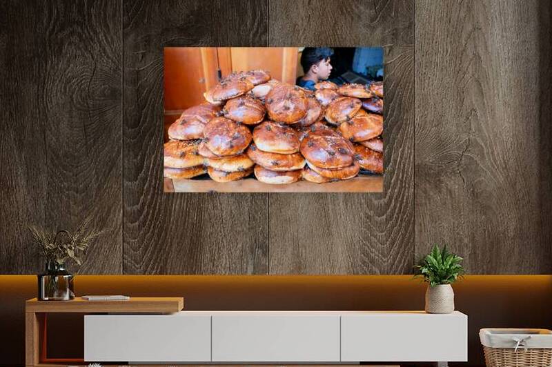 Loaf of bread covered in flies at market in Fez Morocco by Marco Brivio