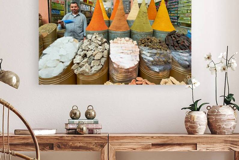 Spice seller in souk of Marrakesh shows colorful spices in Moroc by Marco Brivio