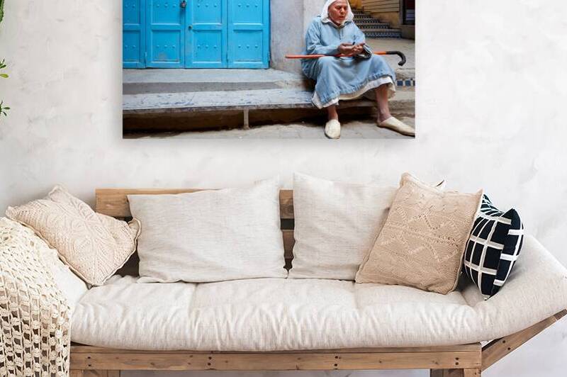 Portrait of a beggar sitting by a blue door in Fez Morocco by Marco Brivio
