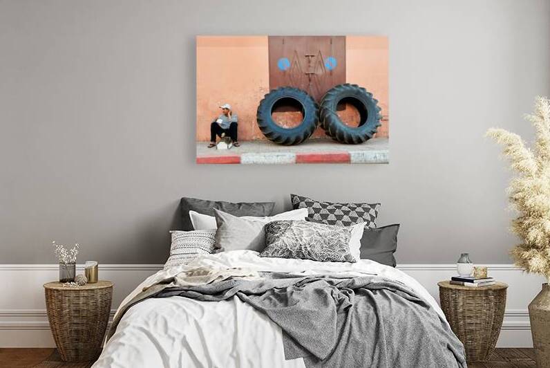 Shoe shine service in Marrakesh old town near large tires by Marco Brivio