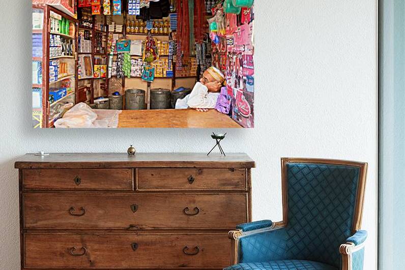 Grocer sleeping in shop in Marrakesh during afternoon hours by Marco Brivio