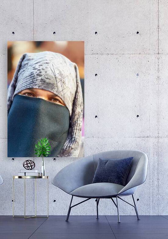 Veiled Moroccan woman in Marrakesh market on a sunny day by Marco Brivio