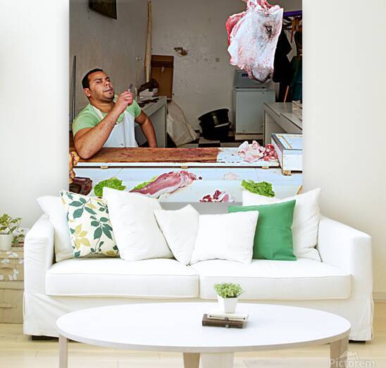 Butcher at work in Meknes souk showing fresh meat and livestock by Marco Brivio