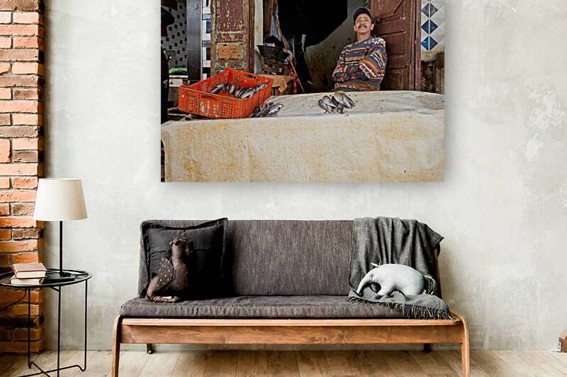 Fishmonger sits by his stall in Meknes Morocco market by Marco Brivio