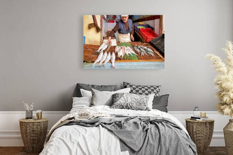 Fishmonger at work in Meknes market selling fresh catch of the d by Marco Brivio