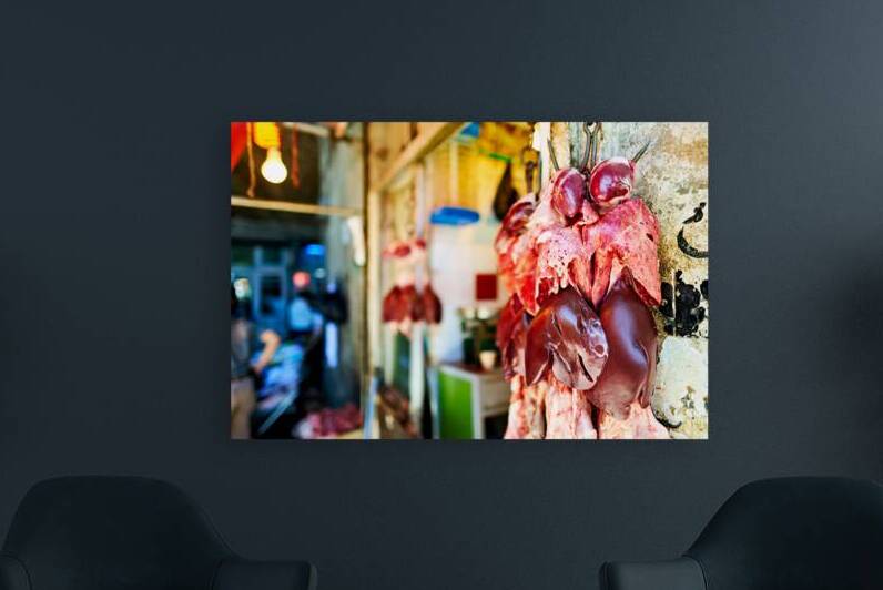 Butcher displays meat at souq in Aleppo Syria during the day by Marco Brivio