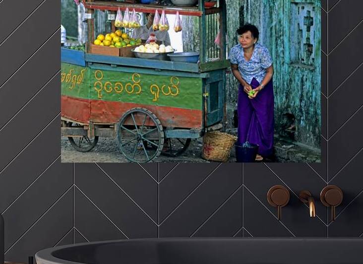 Fruit vendor at street market in Yangon during the day by Marco Brivio