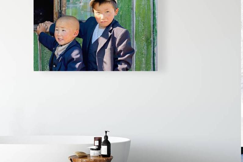 Children in Mongolia standing by a green wooden door by Marco Brivio