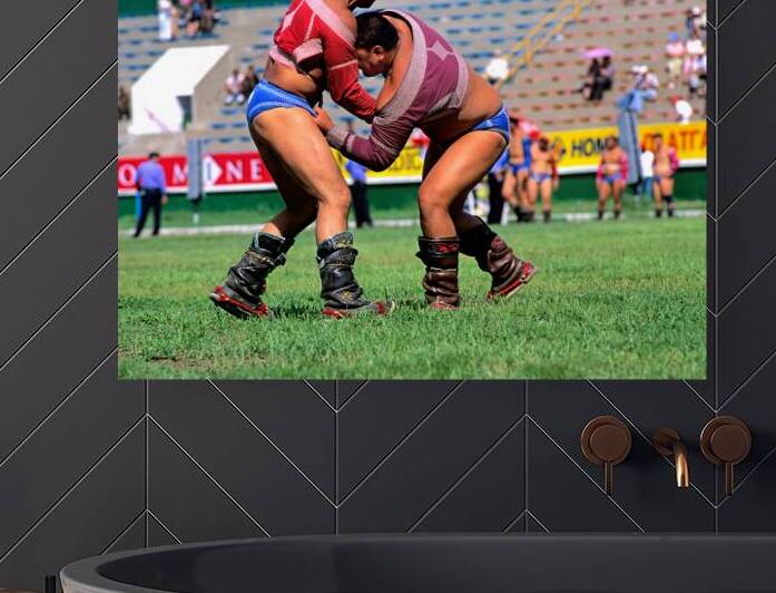 Wrestlers compete during Naadam festival at Ulaanbaatar stadium by Marco Brivio