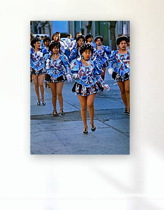 Women dance in blue costumes during a street parade in Argentina by Marco Brivio