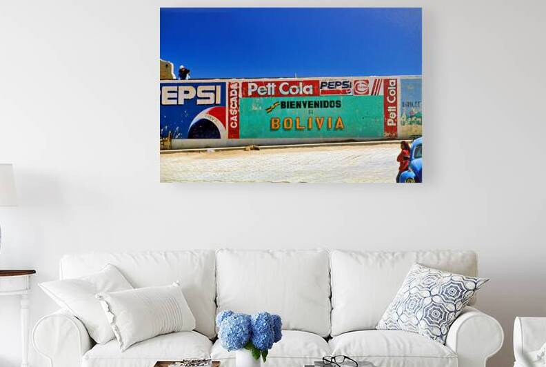 Welcome to Bolivia sign on a wall with old ads. by Marco Brivio