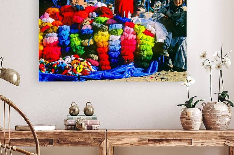 Vibrant market stall with colorful yarn and a smiling child. by Marco Brivio