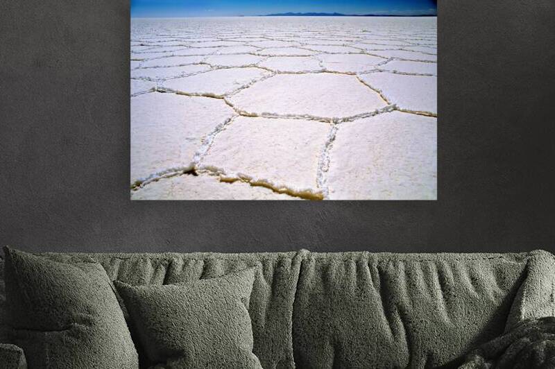 Expansive white salt flat with geometric patterns. by Marco Brivio