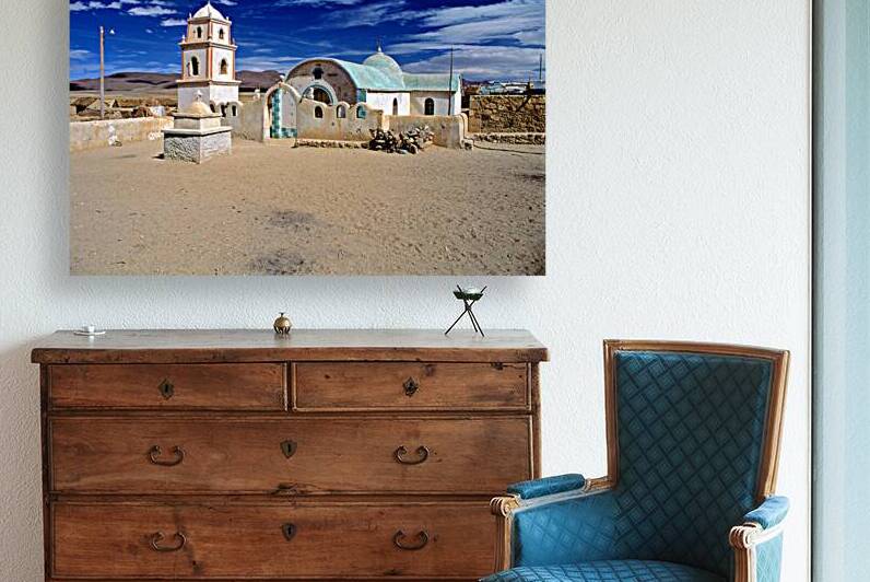 Remote desert church with bell tower under a dramatic sky. by Marco Brivio
