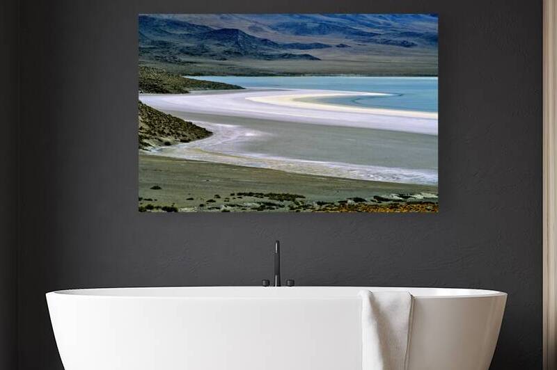 Scenic desert lake with white shore and rocky mountains. by Marco Brivio