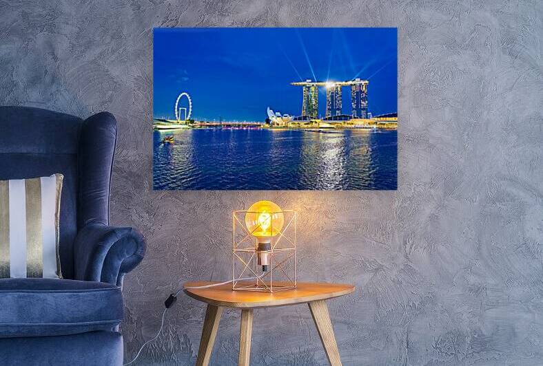 Sunset view of Marina Bay with city skyline and water reflection by Marco Brivio