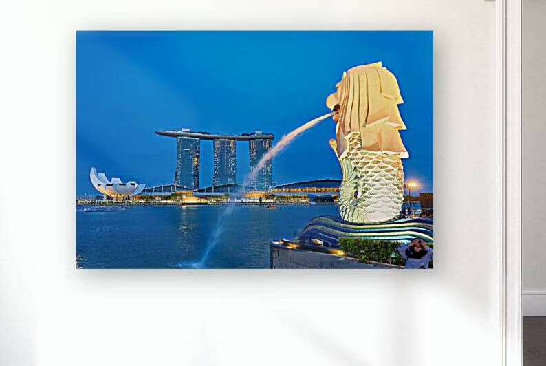 Visitors watch the Merlion fountain at Marina Bay during sunset by Marco Brivio