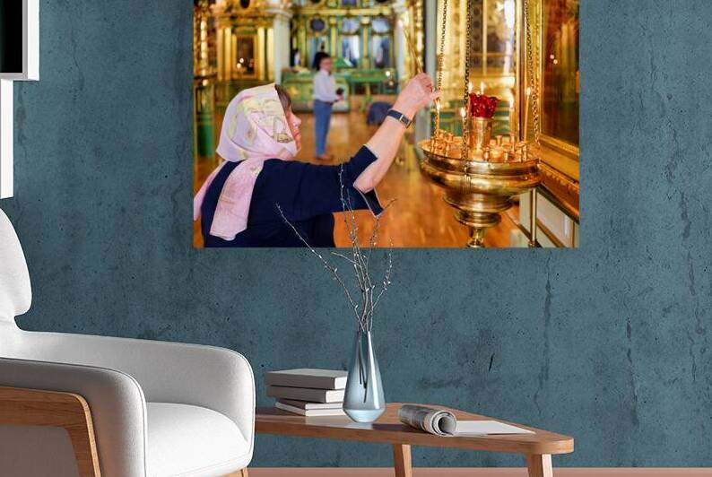 Woman lights a candle in St Nicholas Naval Cathedral by Marco Brivio