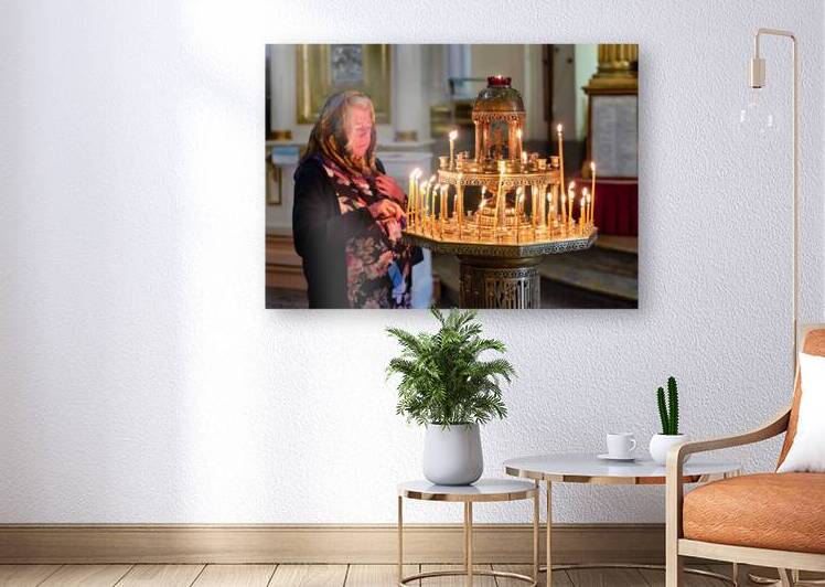 Woman lights candles at Alexander Nevsky Lavra by Marco Brivio