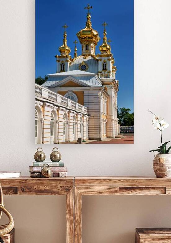 Golden domes of Peterhof Palace stand against blue sky by Marco Brivio
