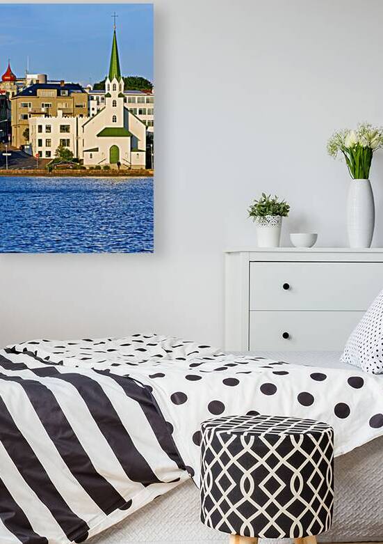 Lutheran free church by lake tjornin in reykjavik iceland by Marco Brivio