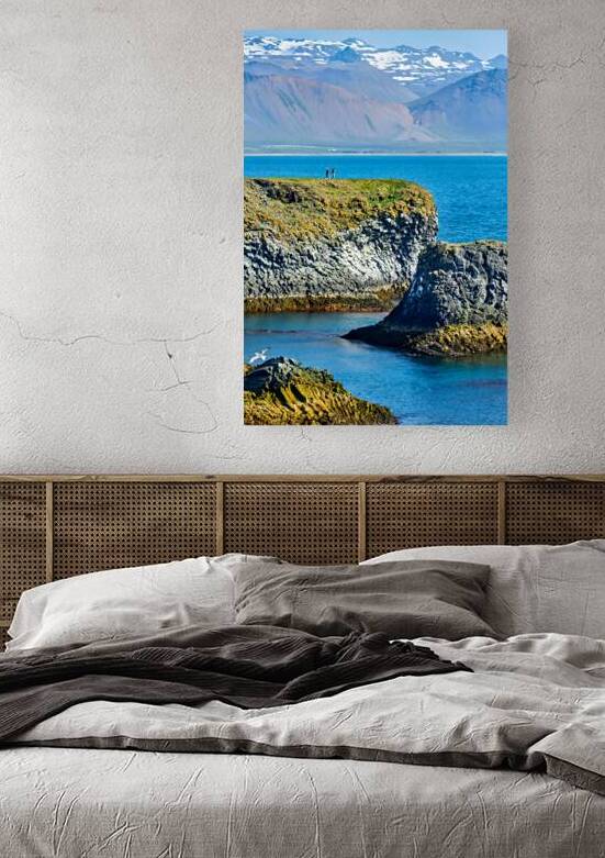 Visitors walk along the Arnarstapi cliff edge in Iceland by Marco Brivio