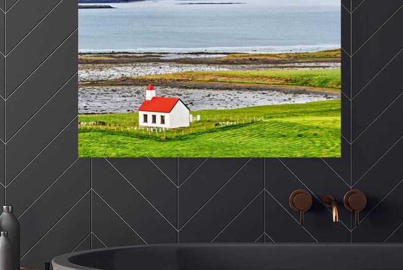 Church stands in western fjords of Iceland near the sea by Marco Brivio