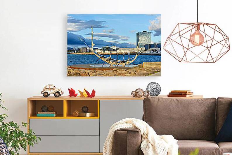 Visitors explore Sun Voyager sculpture in Reykjavik city skyline by Marco Brivio