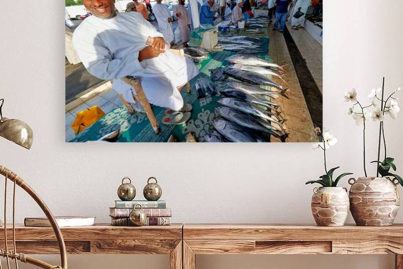 Fish market in Muscat Oman with vendor selling fish by Marco Brivio