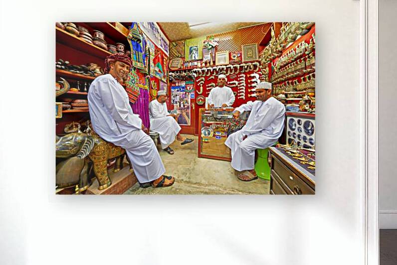 Men sit and talk in shop at Mutrah Souq in Muscat Oman by Marco Brivio
