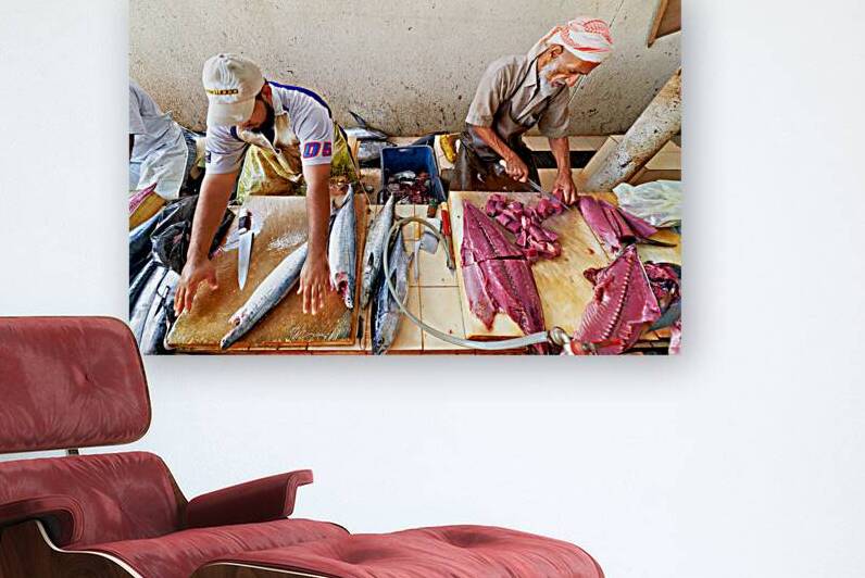 Fish market in Muscat Oman shows workers preparing fish by Marco Brivio