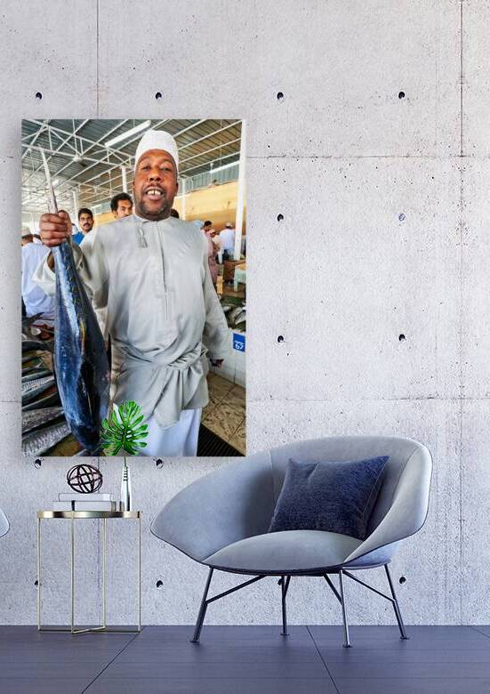 Fish seller shows catch in Muscat Oman fish market by Marco Brivio