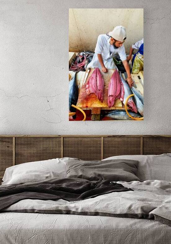 Fish market in Muscat Oman shows a vendor at work by Marco Brivio