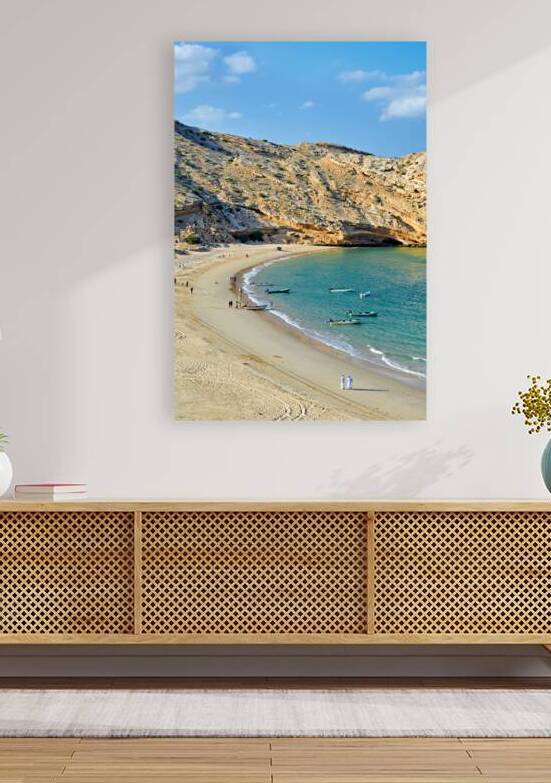 Muscat Oman beaches with boats and people walking along shore by Marco Brivio