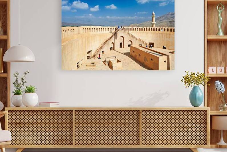 Visit to Nizwa Fort in Oman with visitors and open sky by Marco Brivio