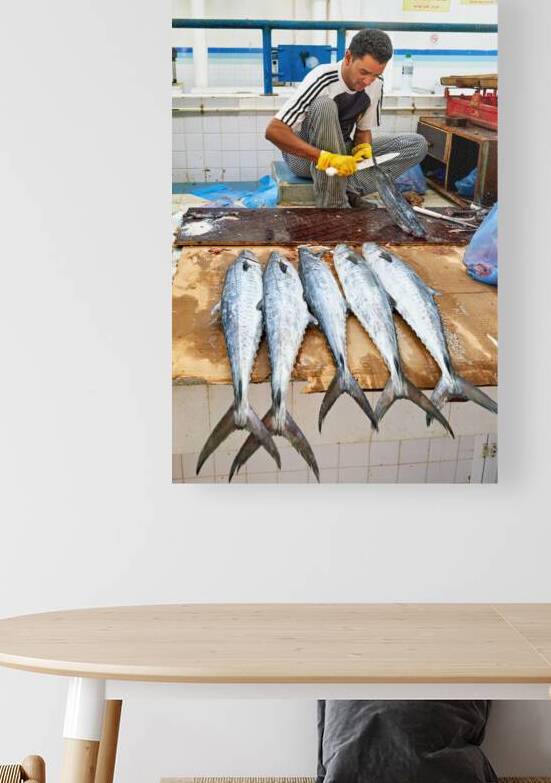 Fish seller prepares catch at Nizwa Oman fish market by Marco Brivio