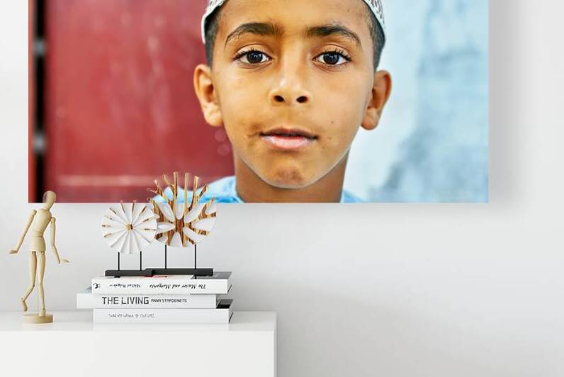 Boy in traditional attire in Muscat Oman during daylight by Marco Brivio