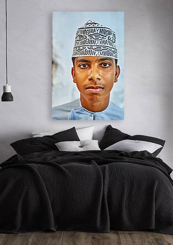 Young boy in traditional attire in Muscat Oman during the day by Marco Brivio