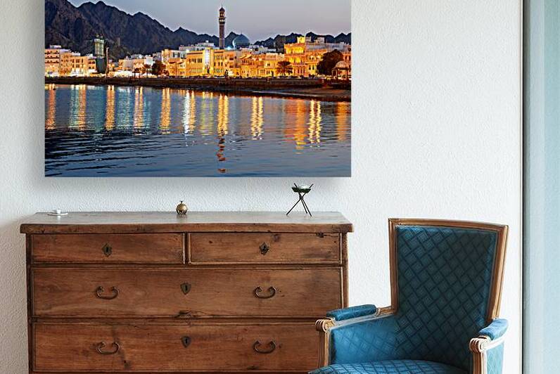 Waterfront view of Muscat Oman during sunset with buildings by Marco Brivio