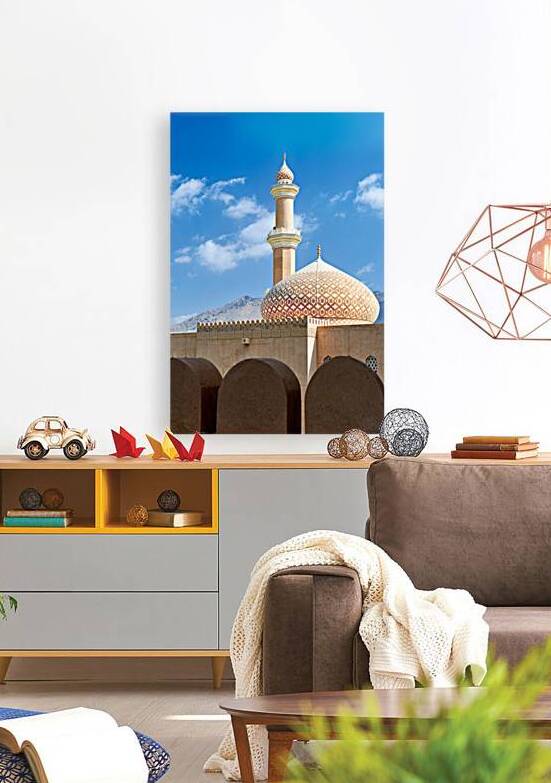 Nizwa Fort shows mosque and tower with blue sky and clouds by Marco Brivio