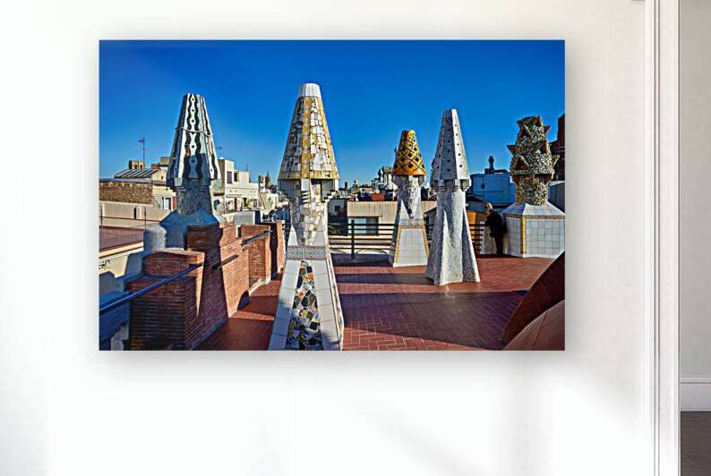 Palau Guell roof with Gaudi sculptures under clear sky by Marco Brivio