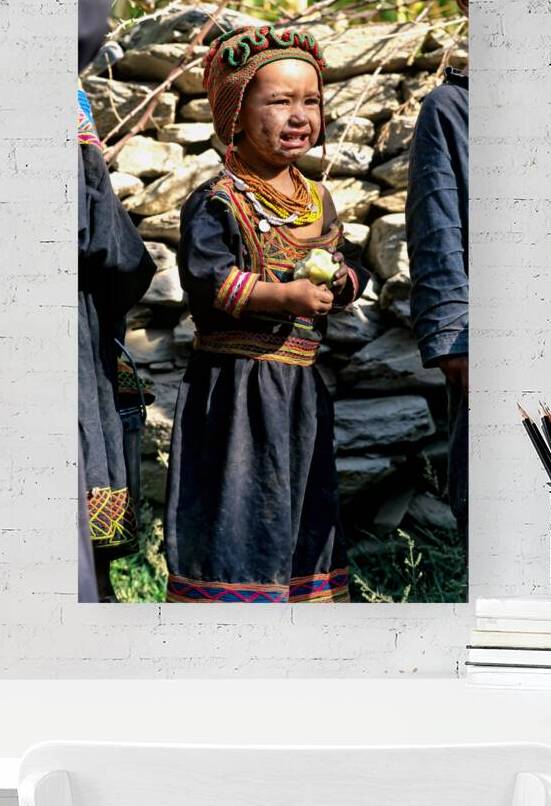 Children gather in a Kalash village wearing traditional clothes by Marco Brivio