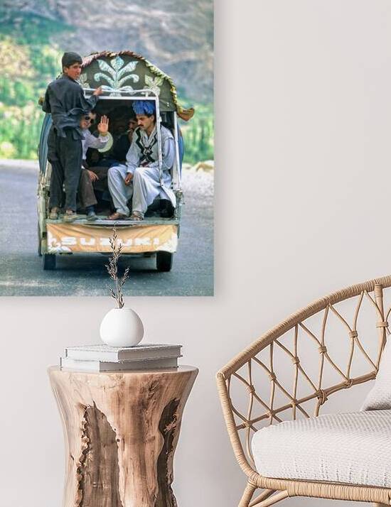 People traveling in a Suzuki on the road to Chitral in Pakistan by Marco Brivio